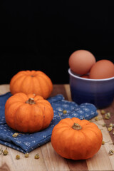 Pumpkins on a wooden table, orange and blue