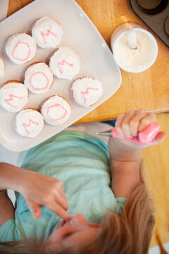 Mother's Day: Girl Licks Icing From Fingers