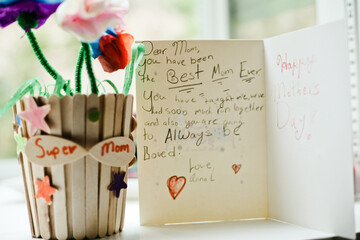 Mother's day card along side a sweet handmade gift from a young girl.