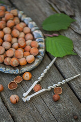Hazelnuts on a vintage dish on a wooden table. Chop nuts, top view.