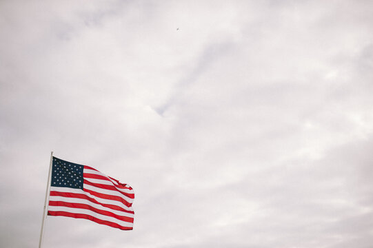 American Flag blowing in a cloudy sky