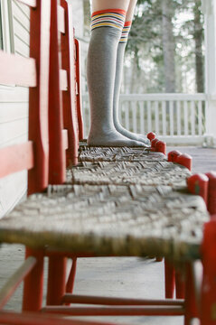 Girl in knee-high socks on orange chairs