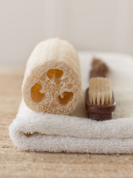 Loofah and brush on towel