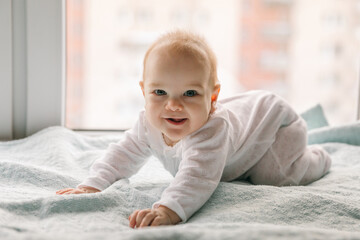 Baby 4-5 months old smiles, learns to stand on all fours and sways