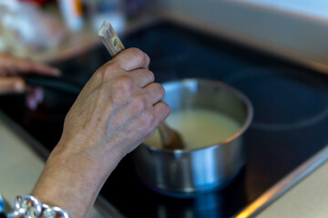 woman cooking soup at home