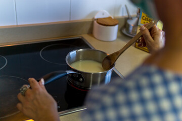 woman cooking soup at home
