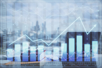 Double exposure of financial chart drawings and desk with open notebook background. Concept of forex market