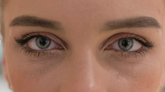 Close up of Blinking Eyes pf of Woman Looking at the Camera