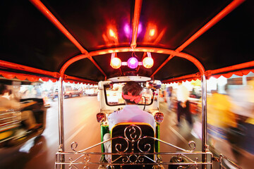 Tuk Tuk or auto rickshaw in motion at night, Bangkok, Thailand, South East Asia