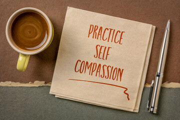 practice self-compassion inspirational handwriting on a napkin with coffee, mindset and personal...