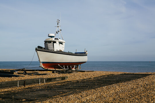 Fishing boat on an empty beach, Kent, UK.