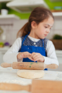Little baker playing with dough.