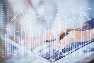 Double exposure of woman hands typing on computer and forex chart hologram drawing. Stock market invest concept.