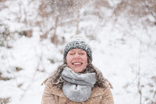 Young woman enjoying the falling snow
