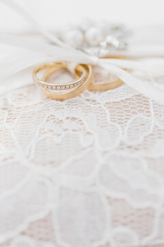 Two gold wedding bands tied with ribbon