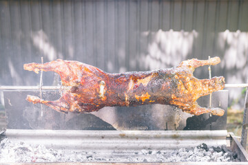 whole lamb roasting on a spit bbq