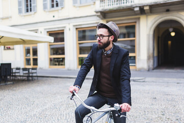 Young man with his bicycle around the city