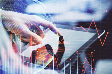 Multi exposure of man's hands holding and using a phone and financial chart drawing. Market analysis concept.