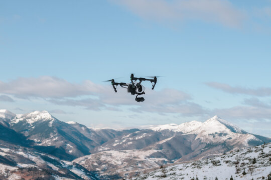 drone flying above snowcovered mountain landscape