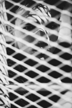 portrait men behind fense