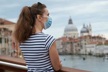 Fototapeta na wymiar woman enjoying promenade on Accademia bridge in Venice, Italy