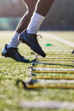 African American athlete training on a football field
