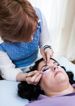 Last stylist attaching temporary lash extensions