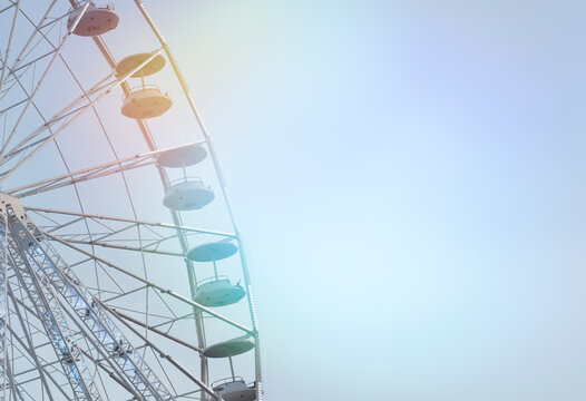 Double exposure of a quarter of a ferris wheel and colorful reflection