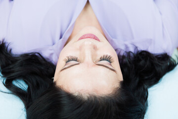 Above view of a young white woman with eyelash extensions