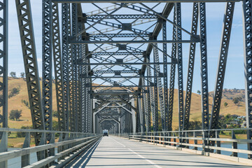 Caravan from behind crossing steel bridge