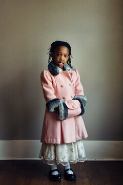 Cute black girl wearing a vintage pink coat