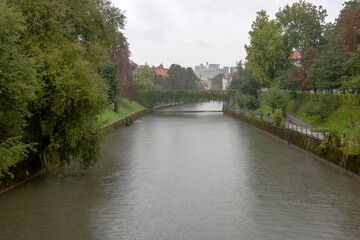 Fototapeta na wymiar The river in old town Ljubljana on a rainy day