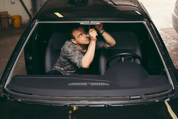 Man Prepares Fixture before Replacing Windshield