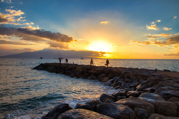 Lahaina breakwall at sunset with Lanai in the distance.