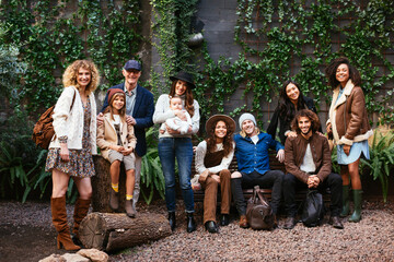 Large diverse family outside suburban house