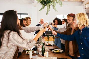 Happy family proposing toast on holiday dinner