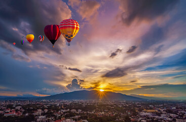 Hot air balloon flying over City landscape and Doi Suthep mountain in Chiang Mai, Thailand
