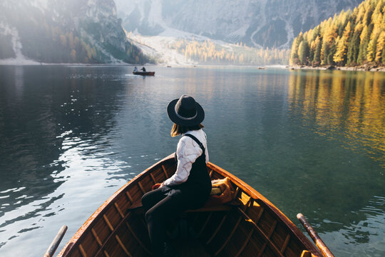 Young Woman In A Wooden Boat In Lake Braies
