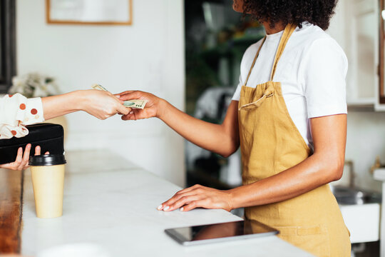 Crop woman paying for order in cafe