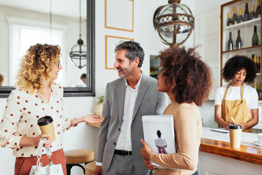 Diverse customers chatting in cafe - Powered by Adobe
