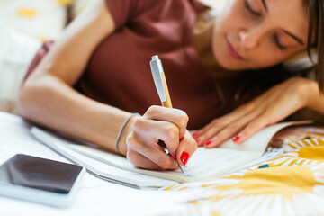 Student doing homework on bed