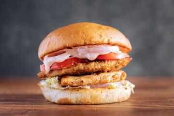 Simple shot of a Double Patty Chicken Burger on a dark background