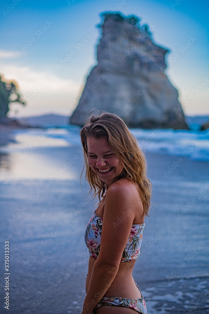 Wall mural young woman in bikini on beach