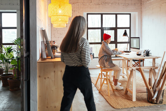 Anonymous woman entering room with working colleague