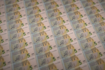 5 euro bills printed in illegal money production conveyor. Collage of many fake bills. Concept of...