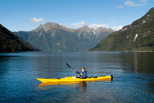 Female paddler, Fiordland National Park, New Zealand.