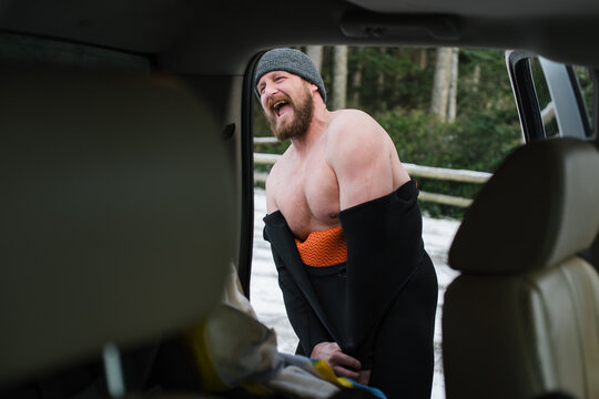 Surfer changing out of wetsuit in winter.