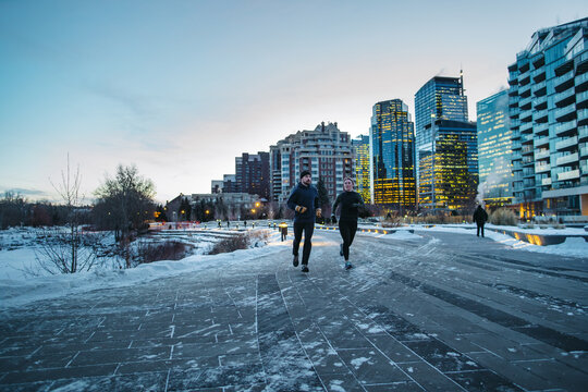 Running couple outside in the cold winter morning.