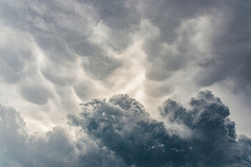 Naklejka na ściany i meble Moody view of dark dramatic storm clouds.