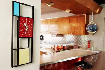 Vintage clock on a wall inside a mid century modern home.